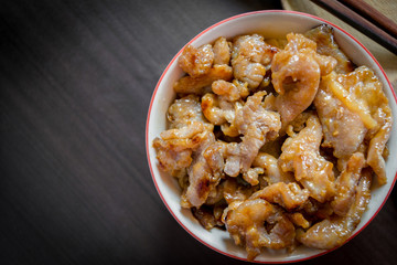 Asian marinated pork or sweet pork in white bowl, wooden chopsticks