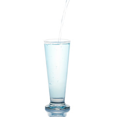Glass with splashing blue drink on a white background