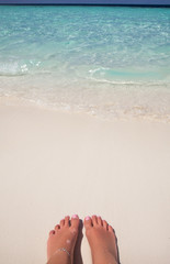 Woman feet closeup of girl relaxing on beach  sunbed enjoying sun  sunny summer day. sandy   the 
