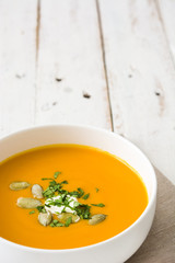 Pumpkin soup on a white wooden table

