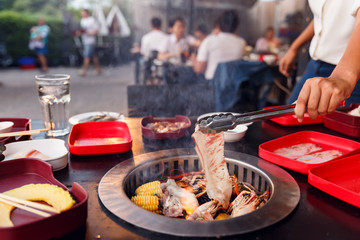 Asian woman are cooking for a group of friends to eat barbecue,Yakiniku