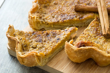 Homemade pumpkin pie on wooden background

