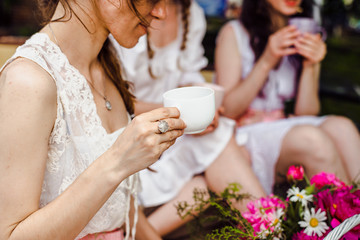 Woman's hands with a cup. Tea or coffee in the cup.