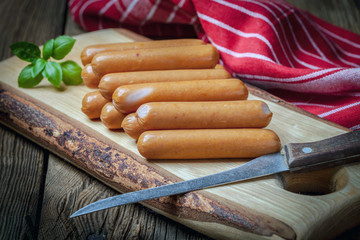 Sausages on the wood board.