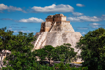 Fototapeta na wymiar Mayan pyramid (Pyramid of the Magician, Adivino) in Uxmal, Mexic