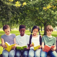 Composite image of children reading books at park
