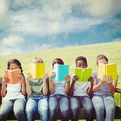 Composite image of children reading books at park