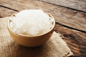 White sea salt in brown bowl in still life style