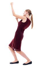 back view of standing girl pulling a rope from the top or cling to something. girl  watching. Rear view people collection.  backside view of person.  Isolated over white background. A girl in a