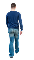 Back view of going  handsome man. walking young guy . Rear view people collection.  backside view of person.  Isolated over white background. bearded man in blue pullover goes away.