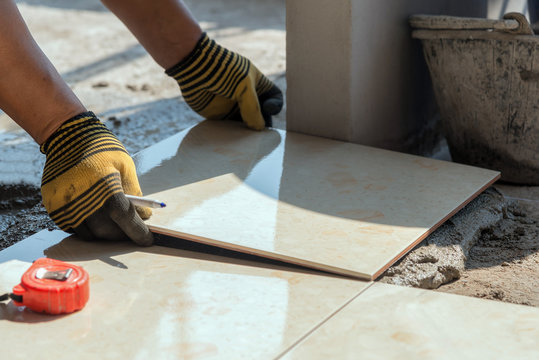 Installing tiles floor in construction work