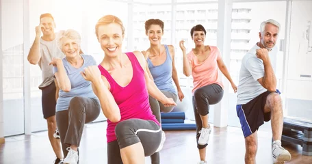 Tuinposter Smiling people doing power fitness exercise at yoga class © vectorfusionart