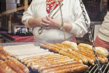 Grilling typical German sausages in a market stall - Oktoberfest - Christmas markets in Germany
