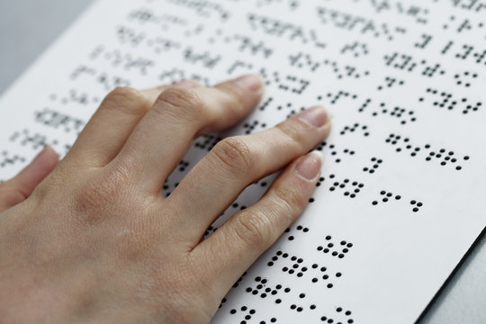 blind reading, fingers and symbols closeup