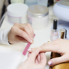 Obraz na płótnie Canvas woman doing a manicure at the beauty salon