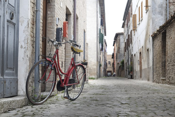 Fototapeta na wymiar Urbania, Italy - August, 1, 2016: bicycle on a street in an ancient part of Urbania, Italy