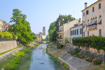 Fototapeta na wymiar PADOVA, ITALY - JULY, 9, 2016: buildings on a river bank in Padova, Italy
