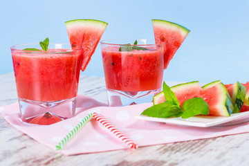 Glasses of watermelon smoothie on a wooden table