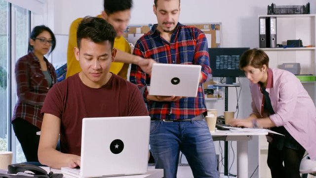  Time lapse of young computer experts working in office with lots of computers