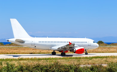 Fototapeta na wymiar white airplane on airport Rhodes island Greece, sunny summer day
