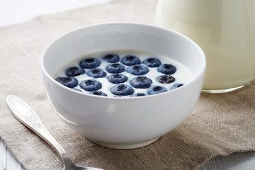 Bowl of fresh blueberries with milk