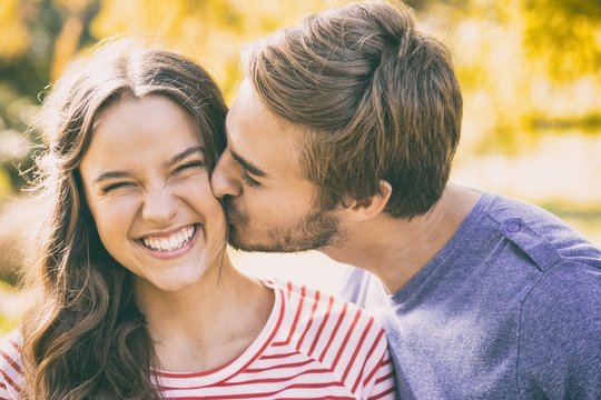 Cute Couple Kissing In The Park