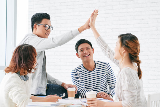 Student giving high five after finishing project