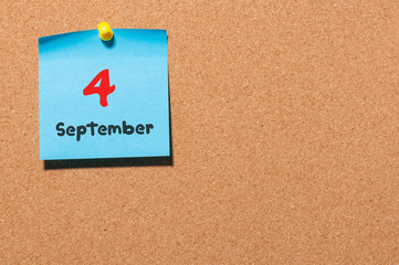 September 4th. Day 4 of month, color sticker calendar on notice board. Autumn time. Empty space for text