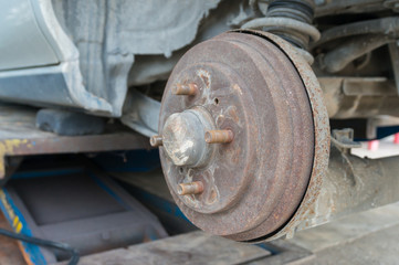 Rusty Rear Car Wheel Hub with Drum Brake System and Suspension