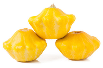 three yellow pattypan squash isolated on white background