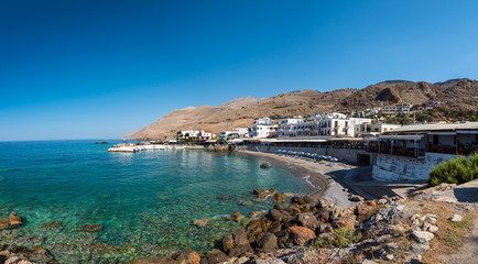 Panoramic view on bay with small beach in centre of Chora Sfakion town, Crete