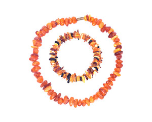 Obraz premium Raw Polished Adult Baltic Amber Necklace and Bracelet Separated on White Background