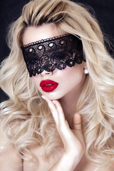 Beautiful Blonde Woman with Black Lace mask over her Eyes. Red Sexy Lips.