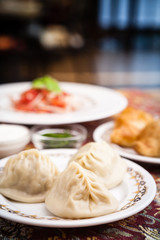 Manti, samosa and tomato salad