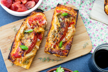 Grilled open faced sandwich with tomato, olives, cheese and chic