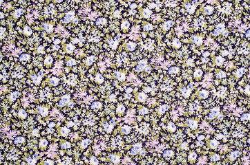Floral pattern on fabric. Pink and blue flowers print as background.