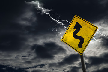 Winding Road Sign With Stormy Background