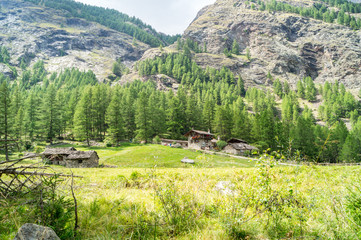 Fototapeta na wymiar Panorama di montagna, casolare montano, vecchie case su sentiero di montagna, baite in montagna, cime montane, alpi italiane