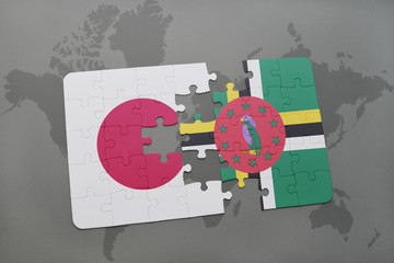 puzzle with the national flag of japan and dominica on a world map background.