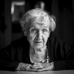 Elderly woman close-up black and white portrait.