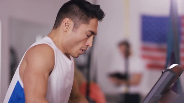  Man training hard at the gym on running machin