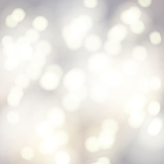 Vector bokeh background. Festive defocused white lights. Abstract blurred illustration.