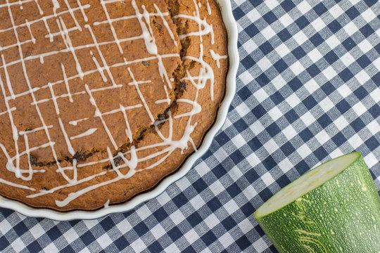 Sweet gingerbread zucchini Pie with lemon topping on blue checke