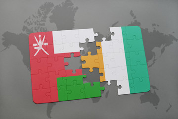 puzzle with the national flag of oman and cote divoire on a world map background.