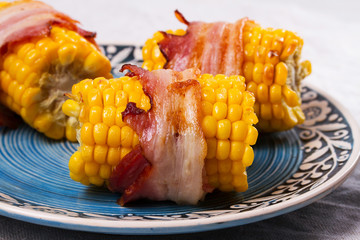 Bacon-wrapped corn in blue plate