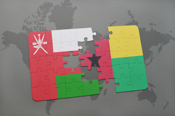 puzzle with the national flag of oman and guinea bissau on a world map background.