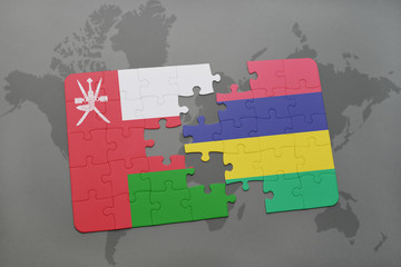 puzzle with the national flag of oman and mauritius on a world map background.