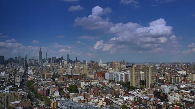 A dramatic day time lapse of puffy summer clouds passing over Midtown Manhattan.  	