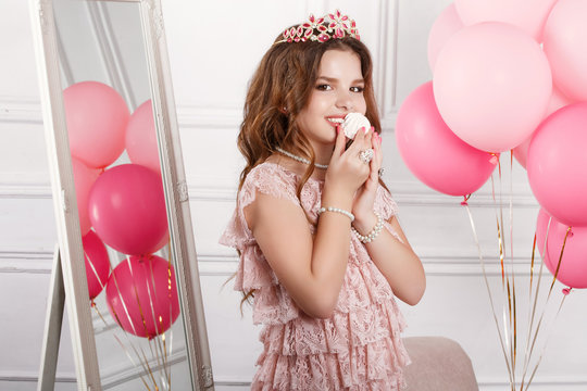 Happy little girl with pink balloons at birthday party