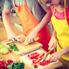 Obraz na płótnie Canvas Couple preparing fresh vegetables salad. Diet